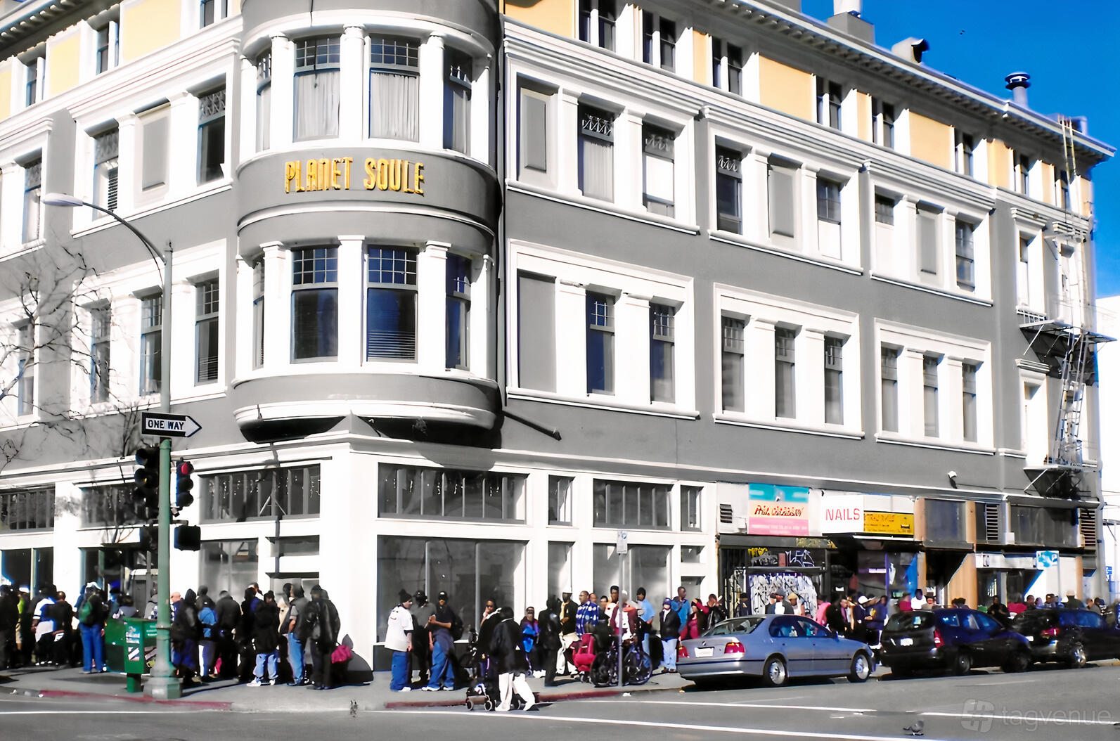 A historic hall with large bay windows and a grey facade on a busy street corner at Geoffrey's Inner Circle.