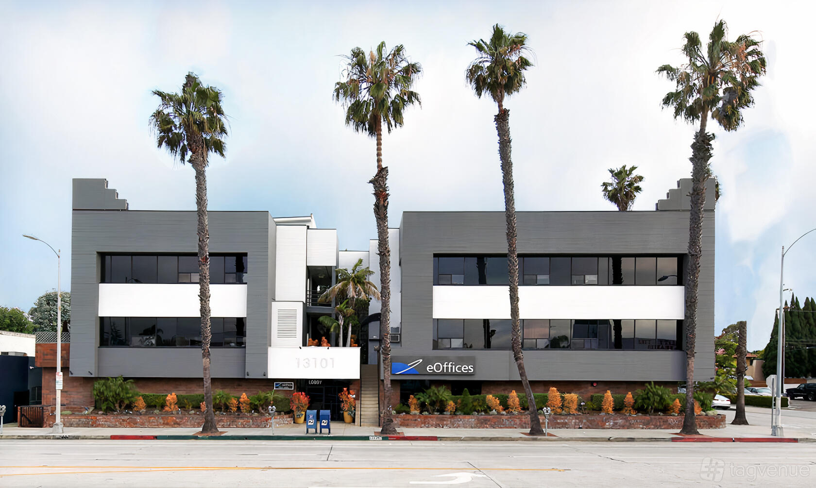 A meeting centre with a modern facade, large windows, and palm trees at eOffices Marina Del Rey.
