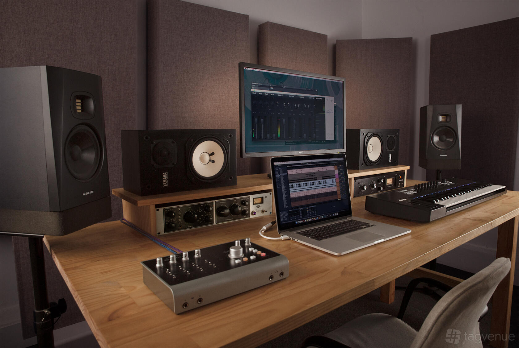 A recording studio with acoustic panels, studio monitors, mixing equipment, and a computer workstation at The Bank Studios.