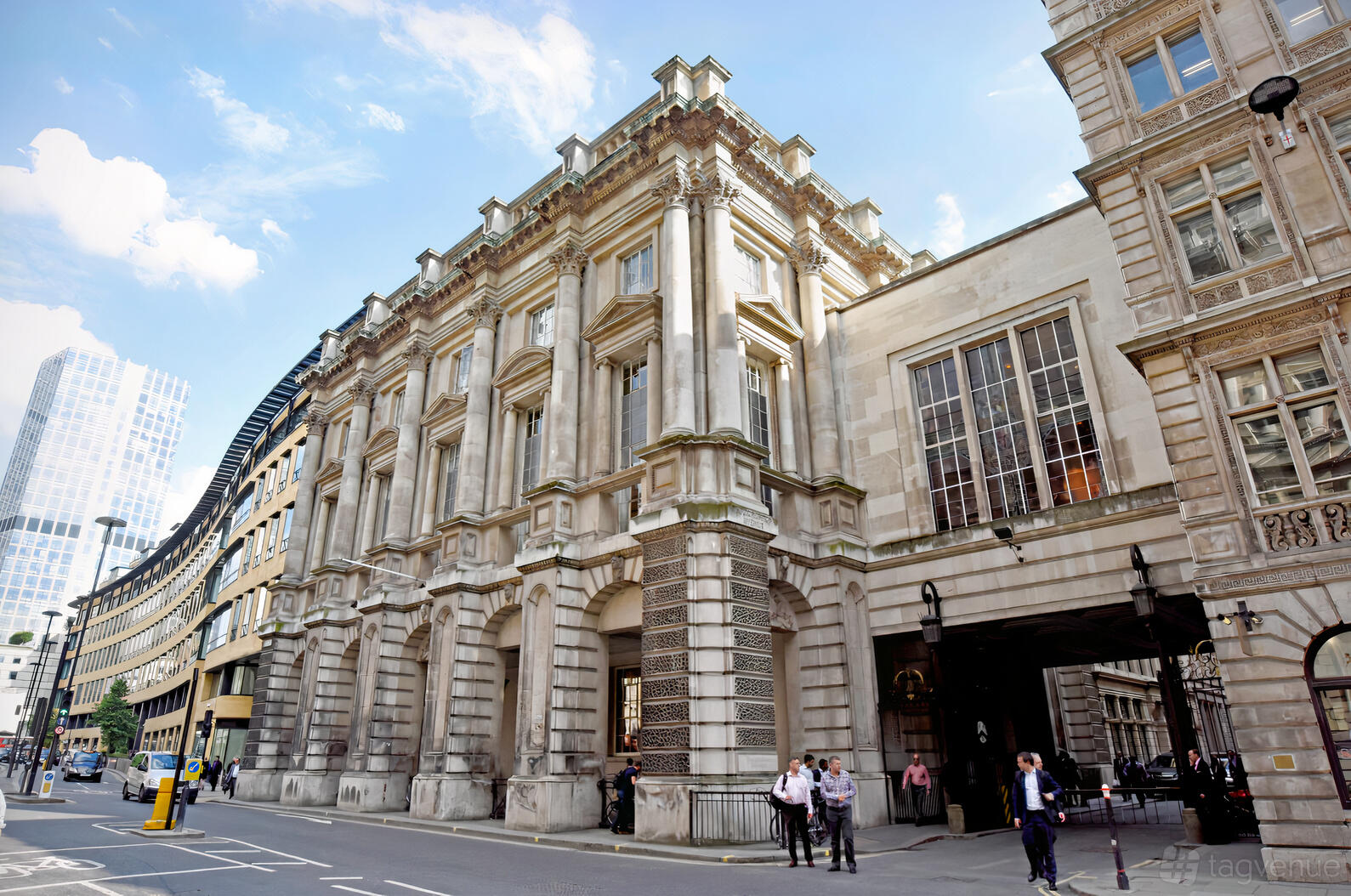 A historic stone hall with grand columns and arched windows on a city street at Carpenters' Hall.