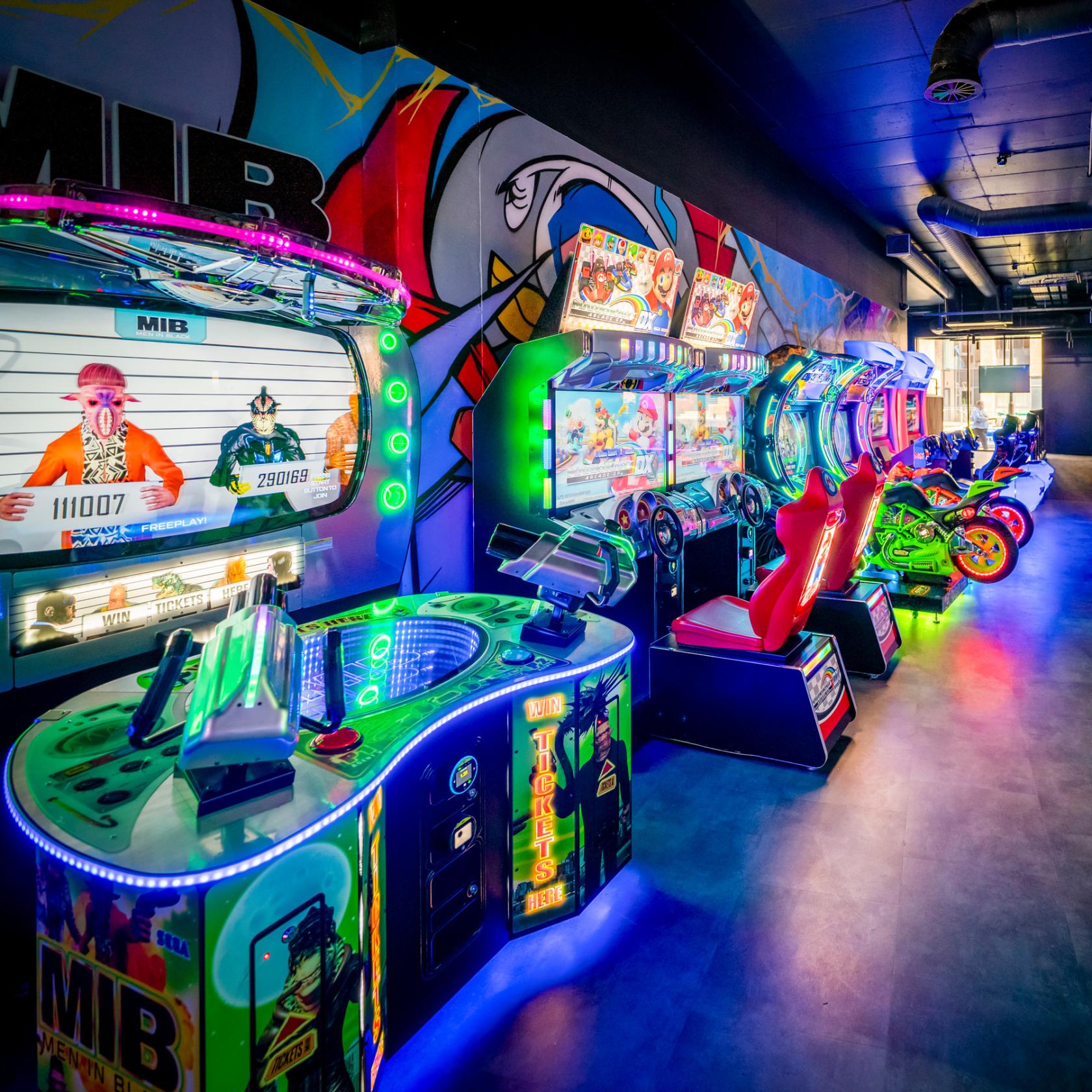 An entertainment centre with colorful arcade game machines and racing simulators at The Light Redhill.