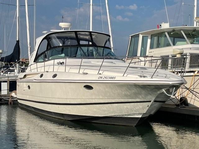 A docked white yacht with a sleek hull and tinted windows at Toronto Yachts.