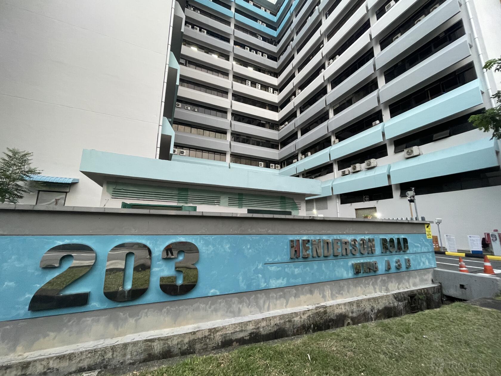 An exterior view of a commercial building with 203 Henderson Road signage at Dinamika Photo Studio.