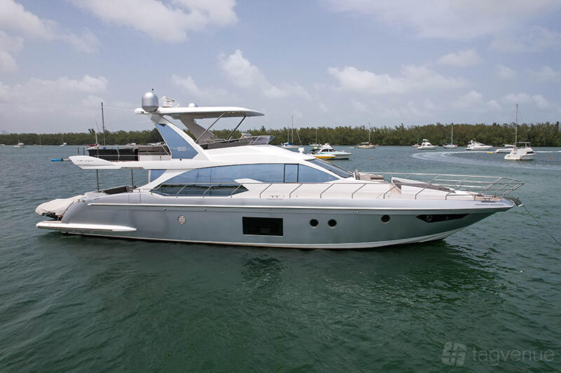 A sleek yacht with a modern white and silver exterior docked on open water at Jerico Yacht Charters.