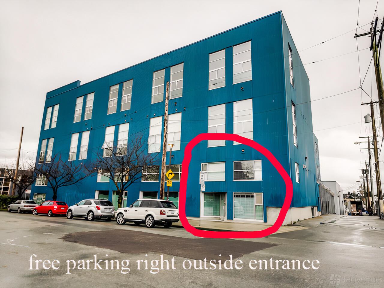 A blue multi-story film and photo studio with large street-facing windows and free parking outside at East Van Photo Video Studio!