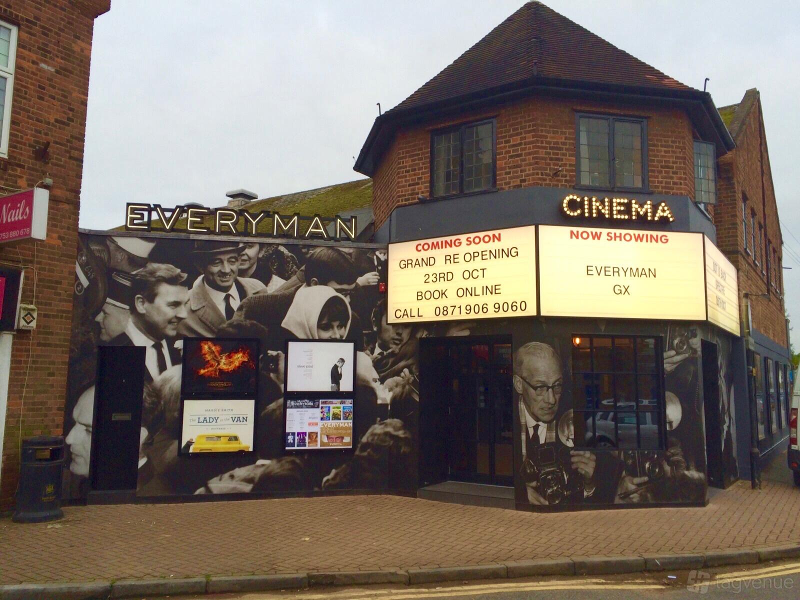 A cinema with a classic marquee, vintage movie posters, and black-and-white mural at Everyman Gerrards Cross.
