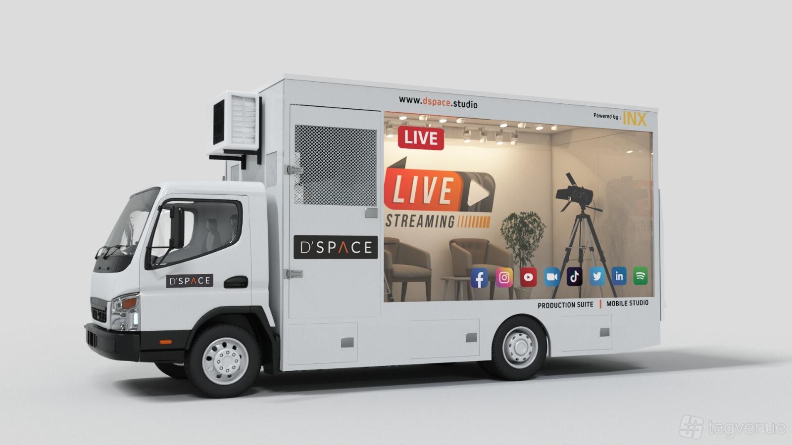 A mobile photo and film studio with floor-to-ceiling window, lounge seating, and camera equipment at Dspace.