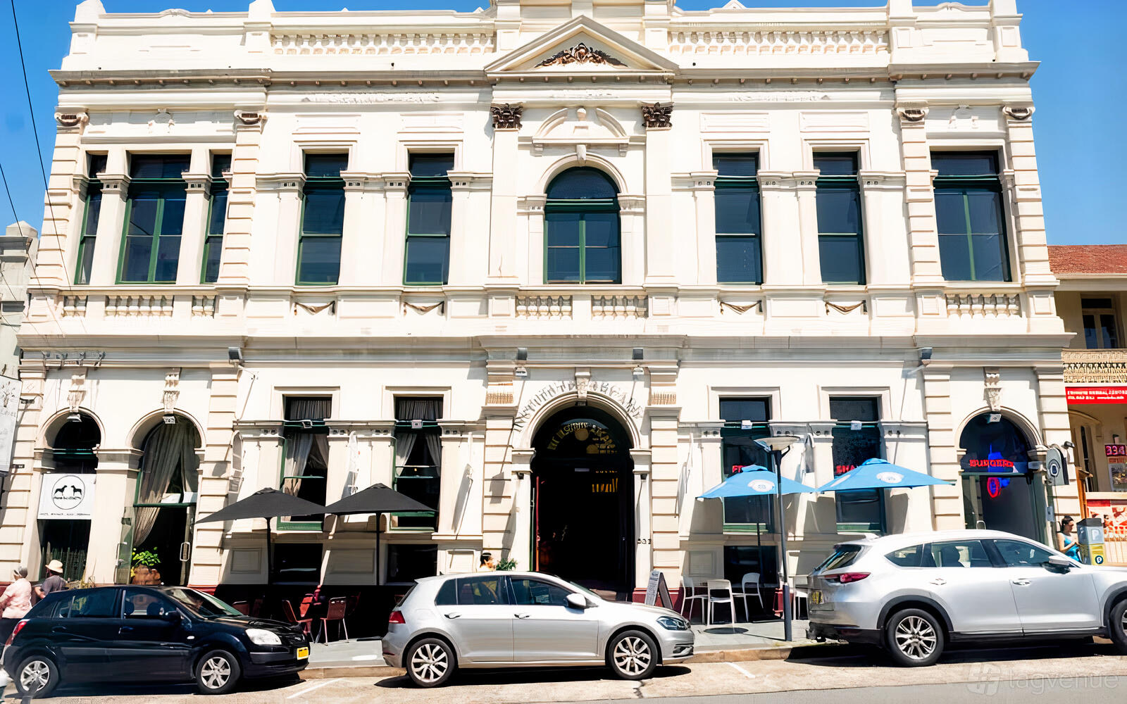 A film and photo studio with a historic cream-colored facade and large arched windows at Art of Light Studios.