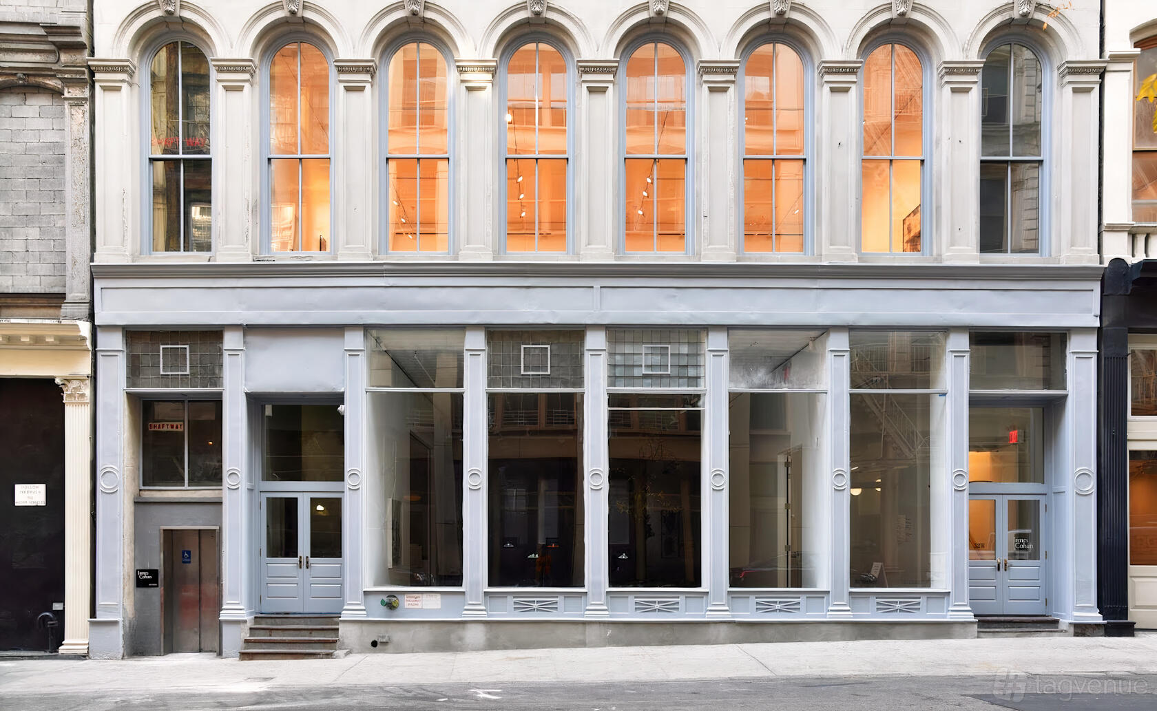 A versatile event space with tall arched windows and a glass storefront exterior at AG Studios.