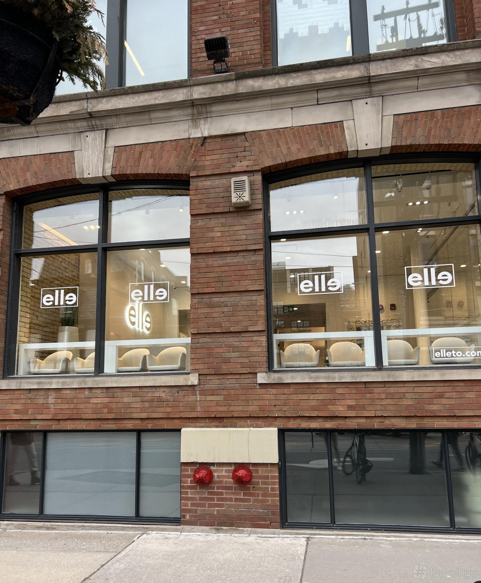 A versatile event space with large street-facing windows, exposed brick exterior, and visible studio seating at Street Level Event & Studio Space.