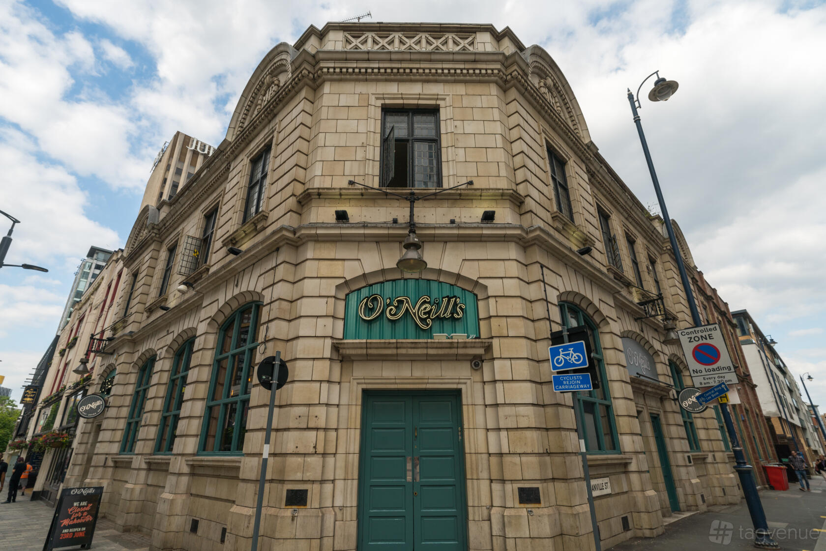 A corner pub with stone facade, arched windows, and green double doors at O'Neill's Broad Street.
