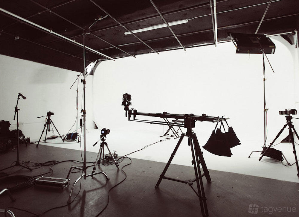 A photo studio with cyclorama wall, studio lights, and camera equipment at M3 Studios.
