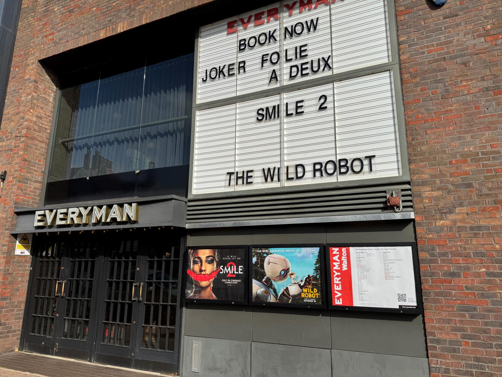 A cinema with a large marquee listing current movies and poster displays at Everyman Walton.
