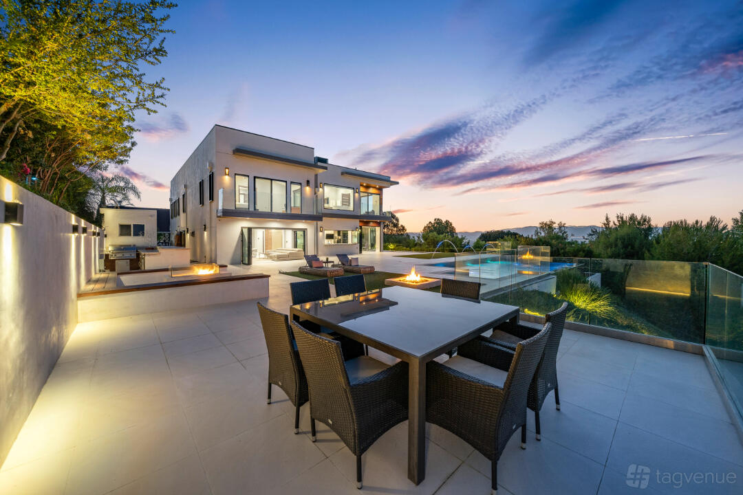 A spacious house with outdoor dining, a fire pit, and a swimming pool at The Gayle Villa.