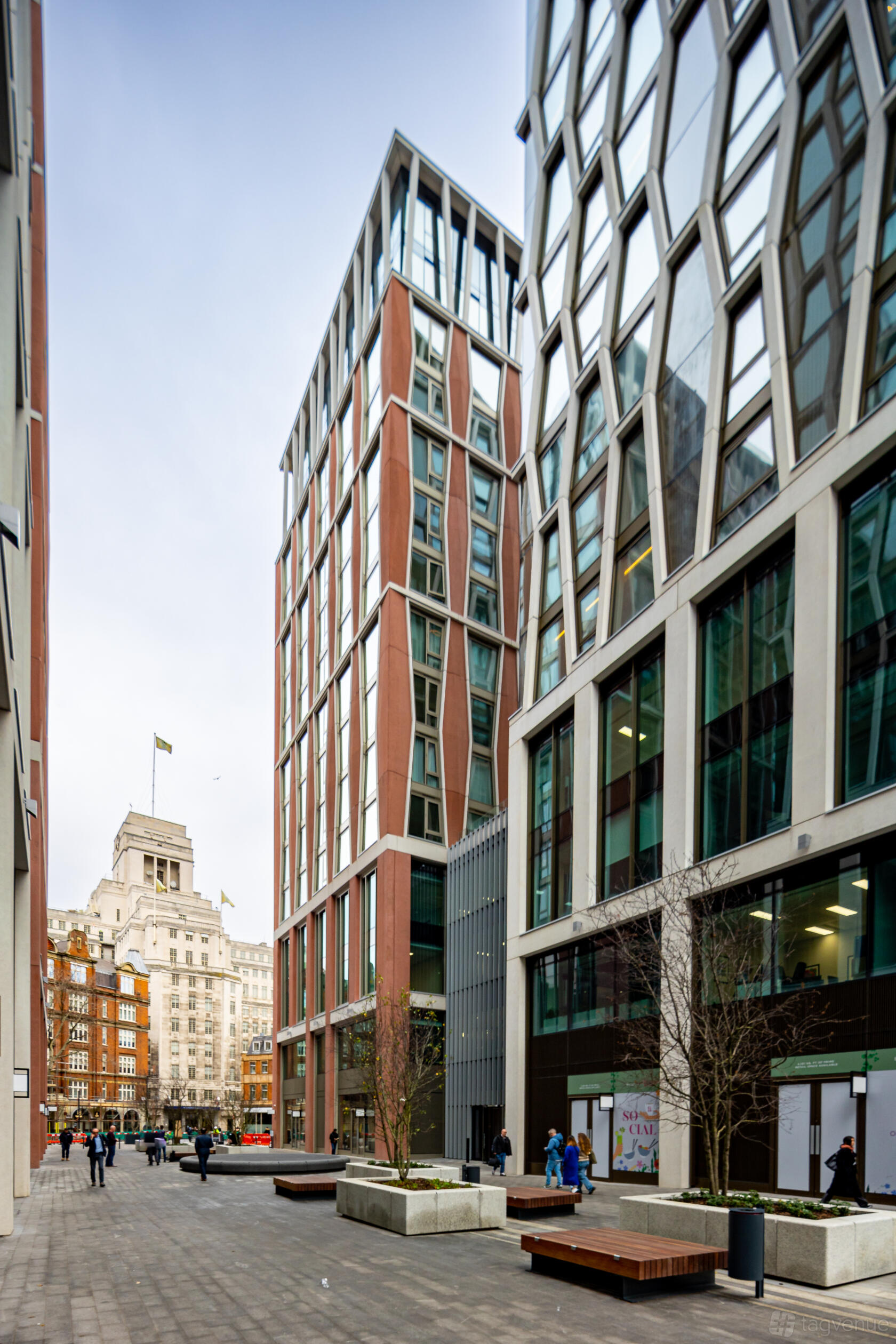 A coworking space with large glass windows in a modern multi-story building at Landmark: Orchard Place, Victoria, London.