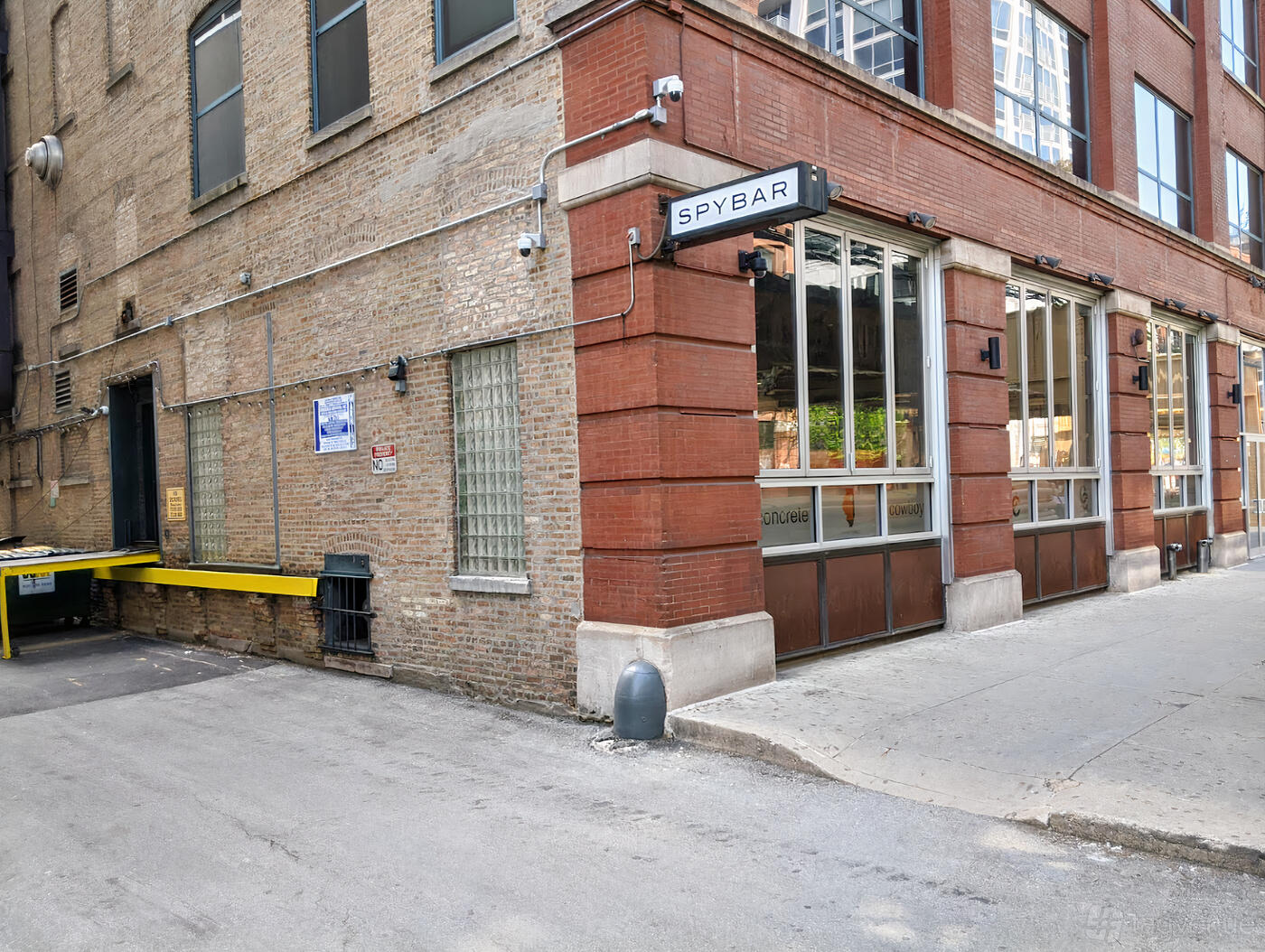 A nightclub with a brick exterior, large windows, and a bold sign above the entrance at Spybar.