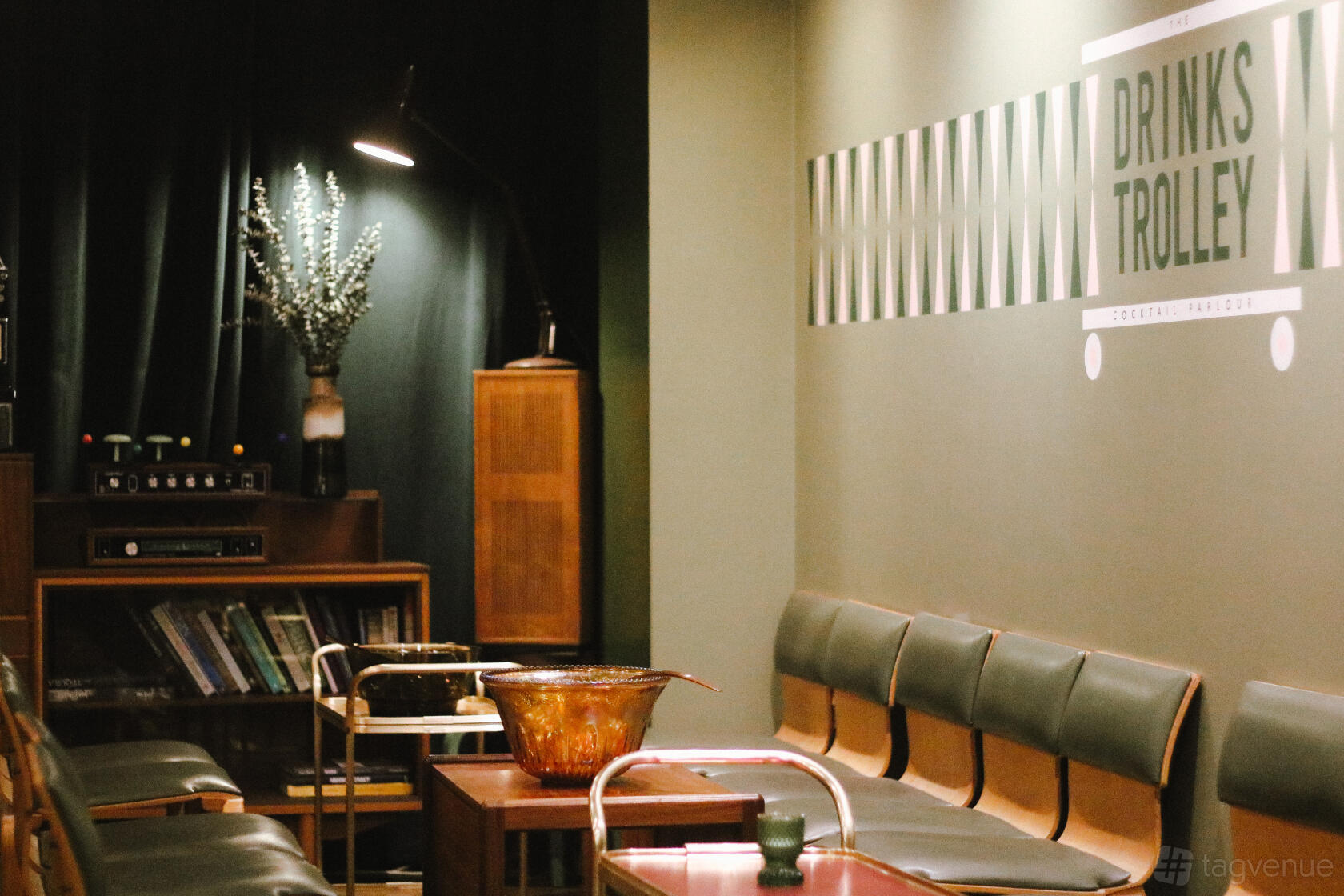 A basement lounge with retro furniture, vinyl records, and a drinks trolley at Bell & Viv.