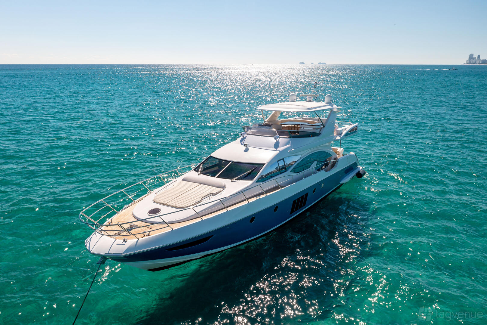 A yacht with spacious decks and sun loungers on open water at Lupo Yachts.
