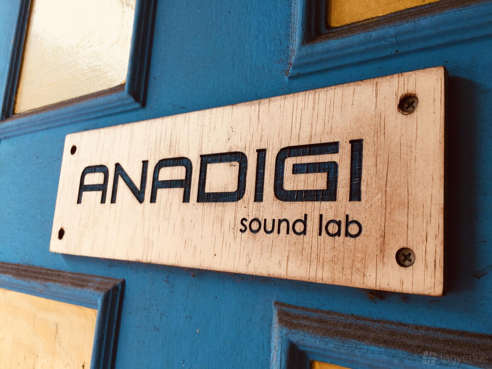 A wooden sign reading 'ANADIGI sound lab' mounted on a blue door at Anadigi.