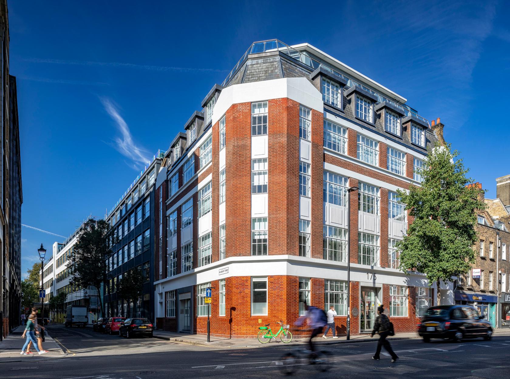 A meeting centre with red brick and large white-framed windows on a corner street at 175 St John's Street.