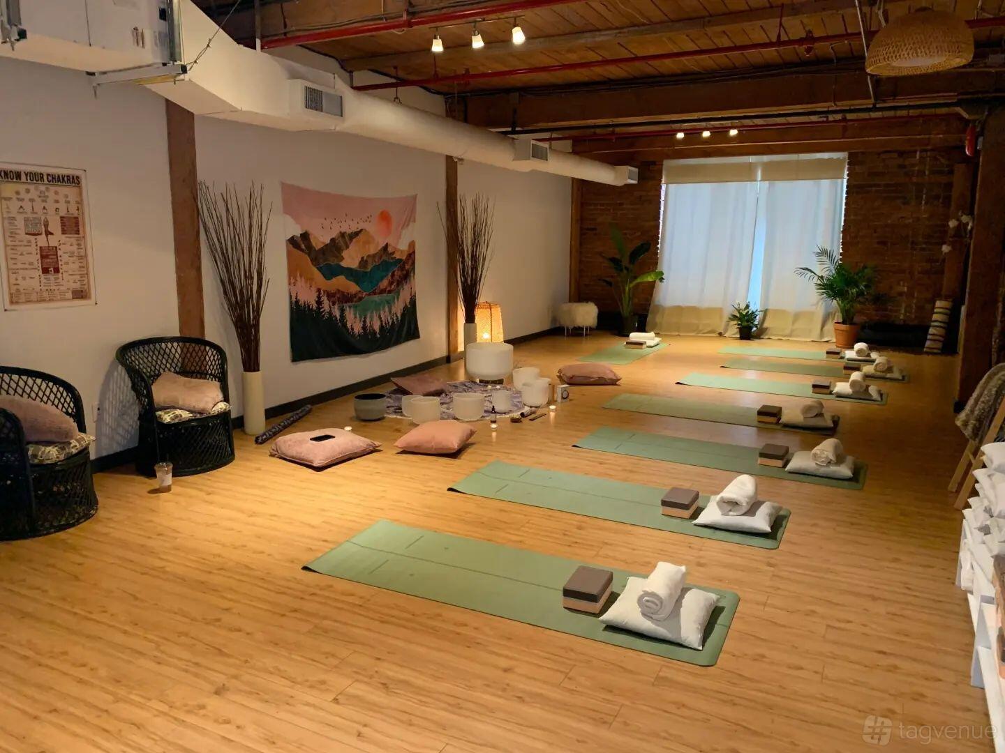 An event venue with yoga mats, meditation cushions, and warm wooden floors at Mandala Studio and Creative Space.