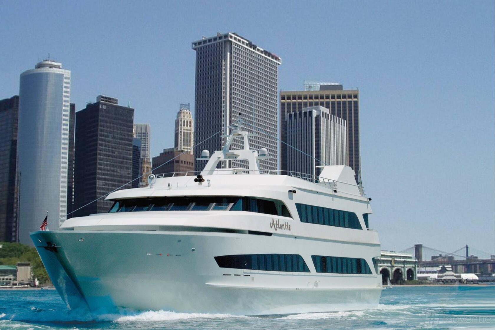 A multi-level yacht with large windows cruising near city skyscrapers at Del Rio Yacht Charter