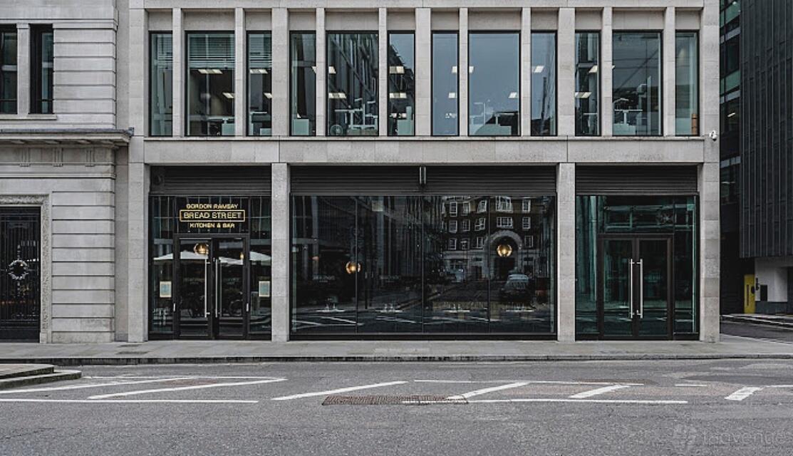 A restaurant with floor-to-ceiling windows and a glass entrance at Bread Street Kitchen, The City.