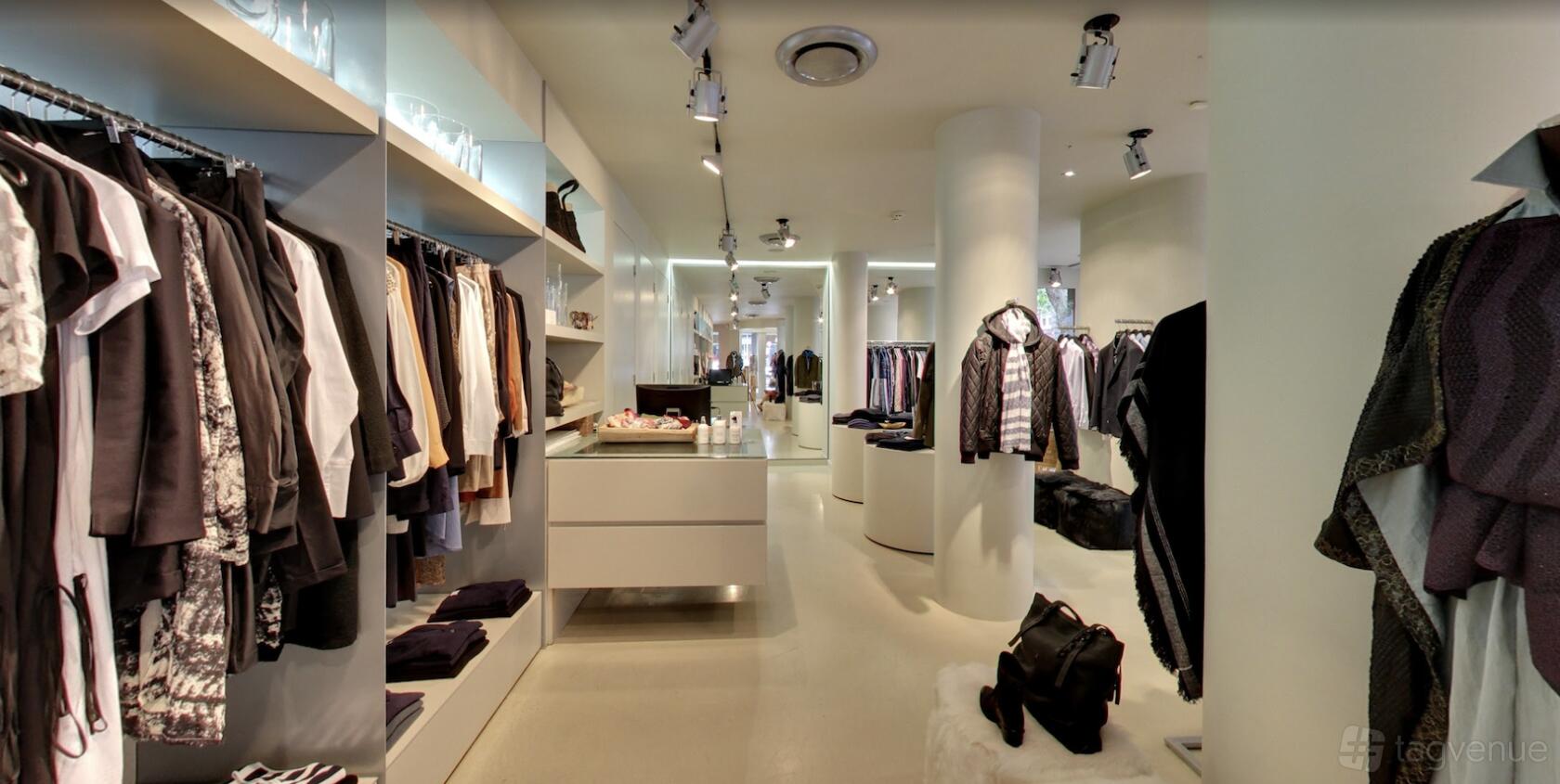 A pop up shop with clothing racks, built-in shelves, and spot lighting at Potts Point Pop Up.