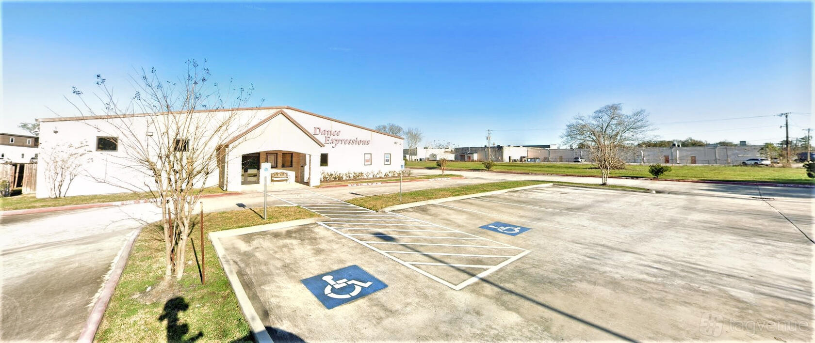 A dance studio with a large accessible parking lot and clear exterior signage at Dance Expressions.