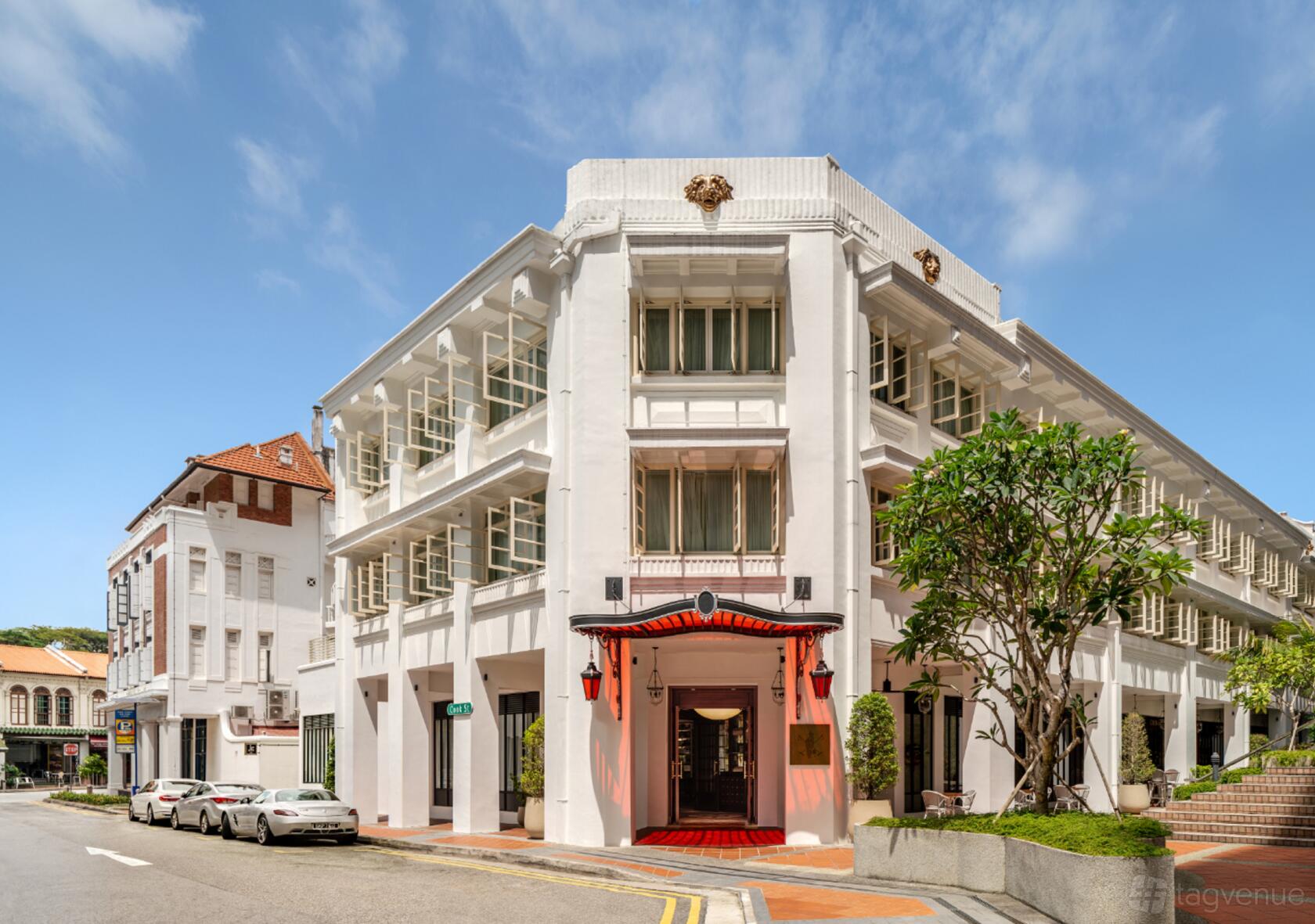 A historic hotel with white colonial architecture, ornate facade, and red-accented entrance at Maxwell Reserve, Autograph Collection.