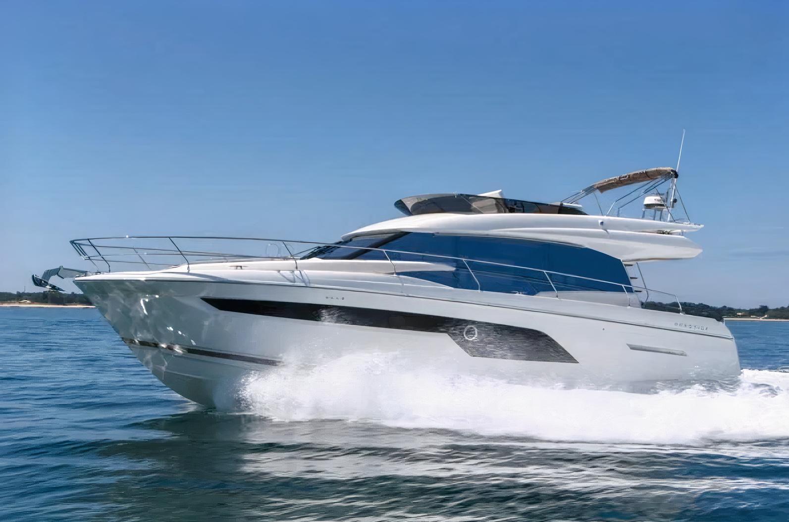 A sleek white yacht with upper deck seating cruising on open water at Lots Of Yachts/Lots Of Spots - New York.