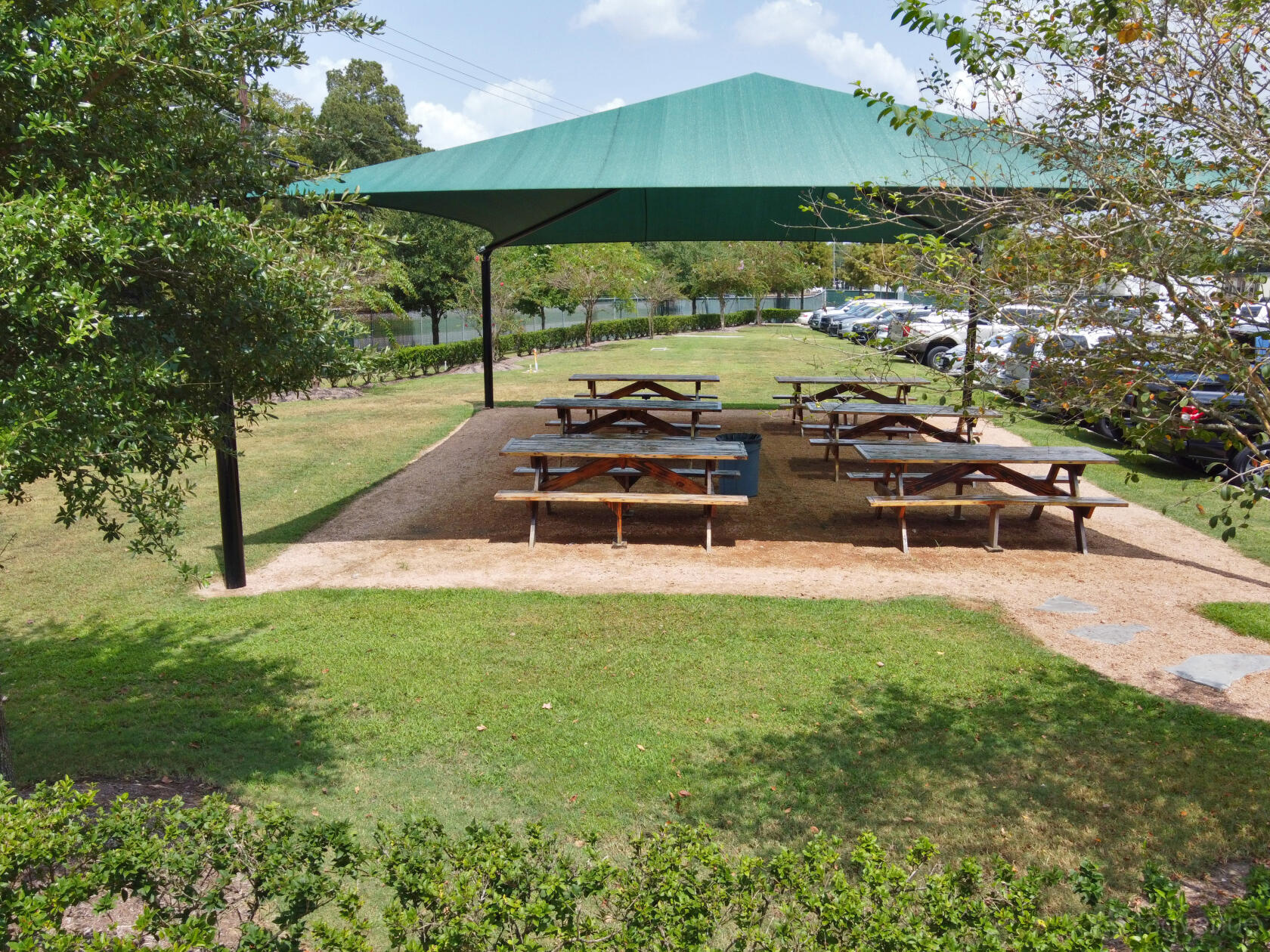 A beer garden terrace with picnic tables under a large green shade canopy at Spindletap Brewery.