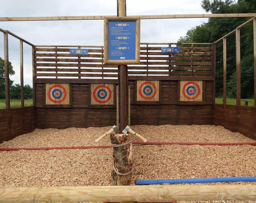 An outdoor event venue with axe target boards and woodchip flooring at Go Ape Matfen.