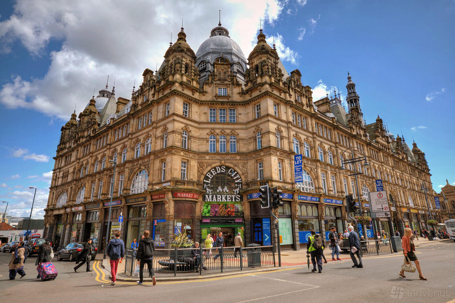 A historic building with ornate stonework, arched windows, and a domed roof at Leeds Kirkgate Market.