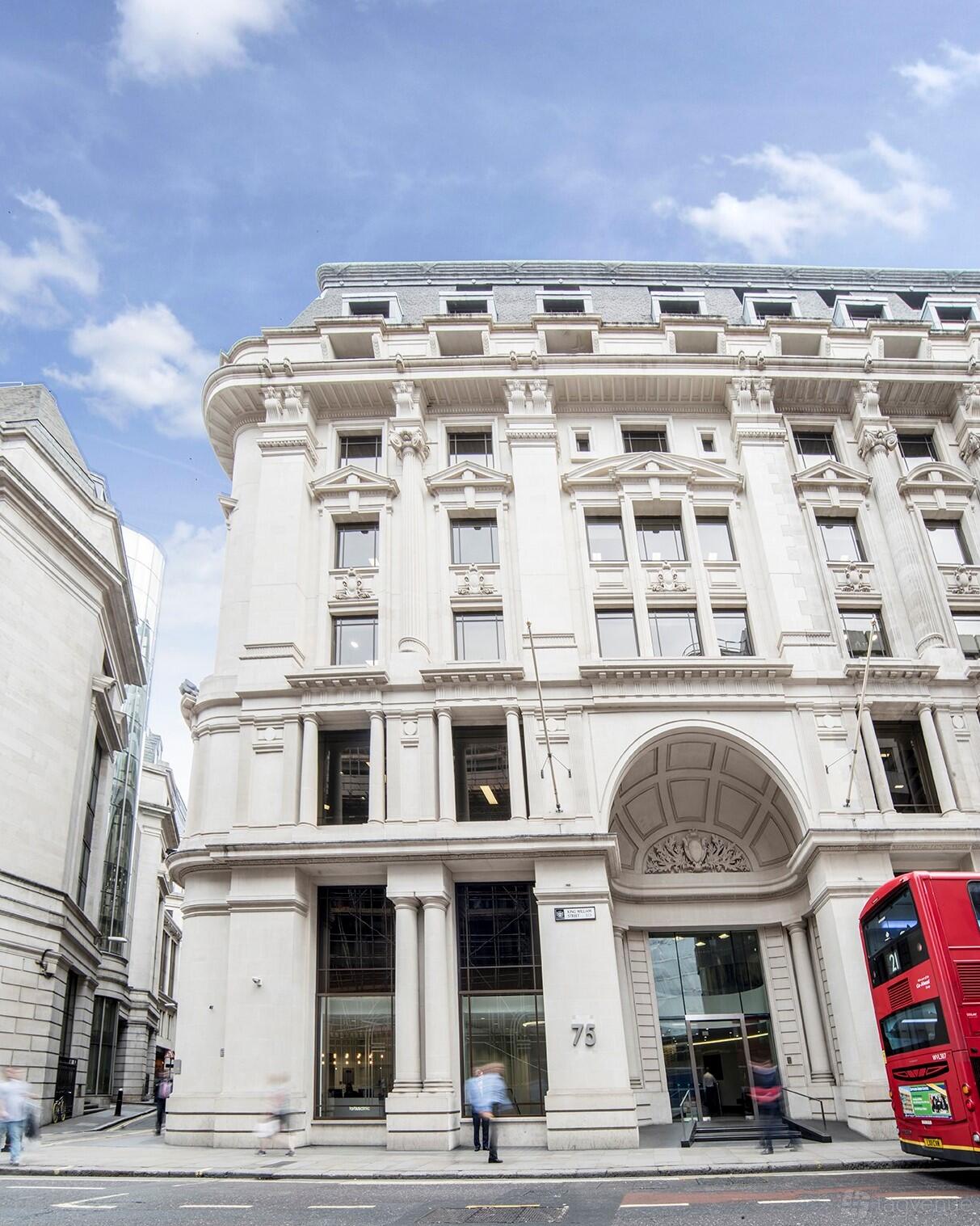 A grand stone meeting centre with arched entryway and ornate detailing at Landmark: King William Street, London.