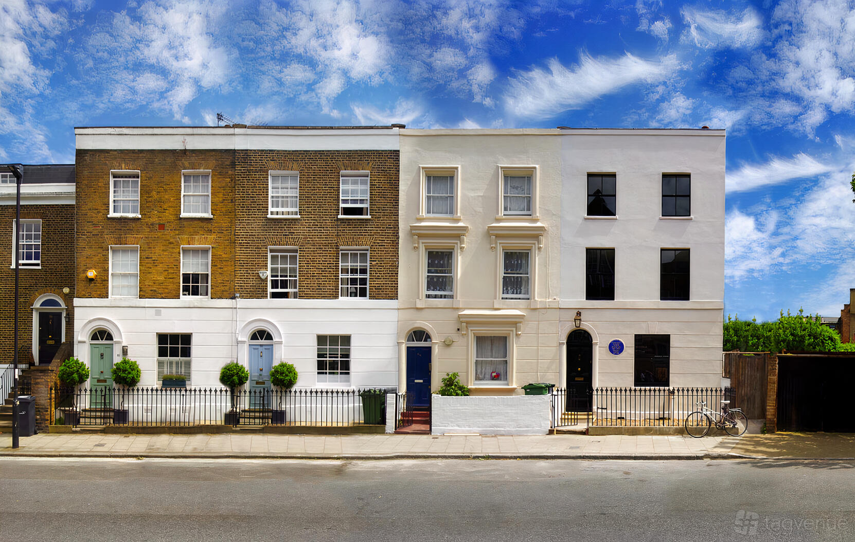 A gallery with a white brick exterior and arched windows facing the street at Van Gogh House.