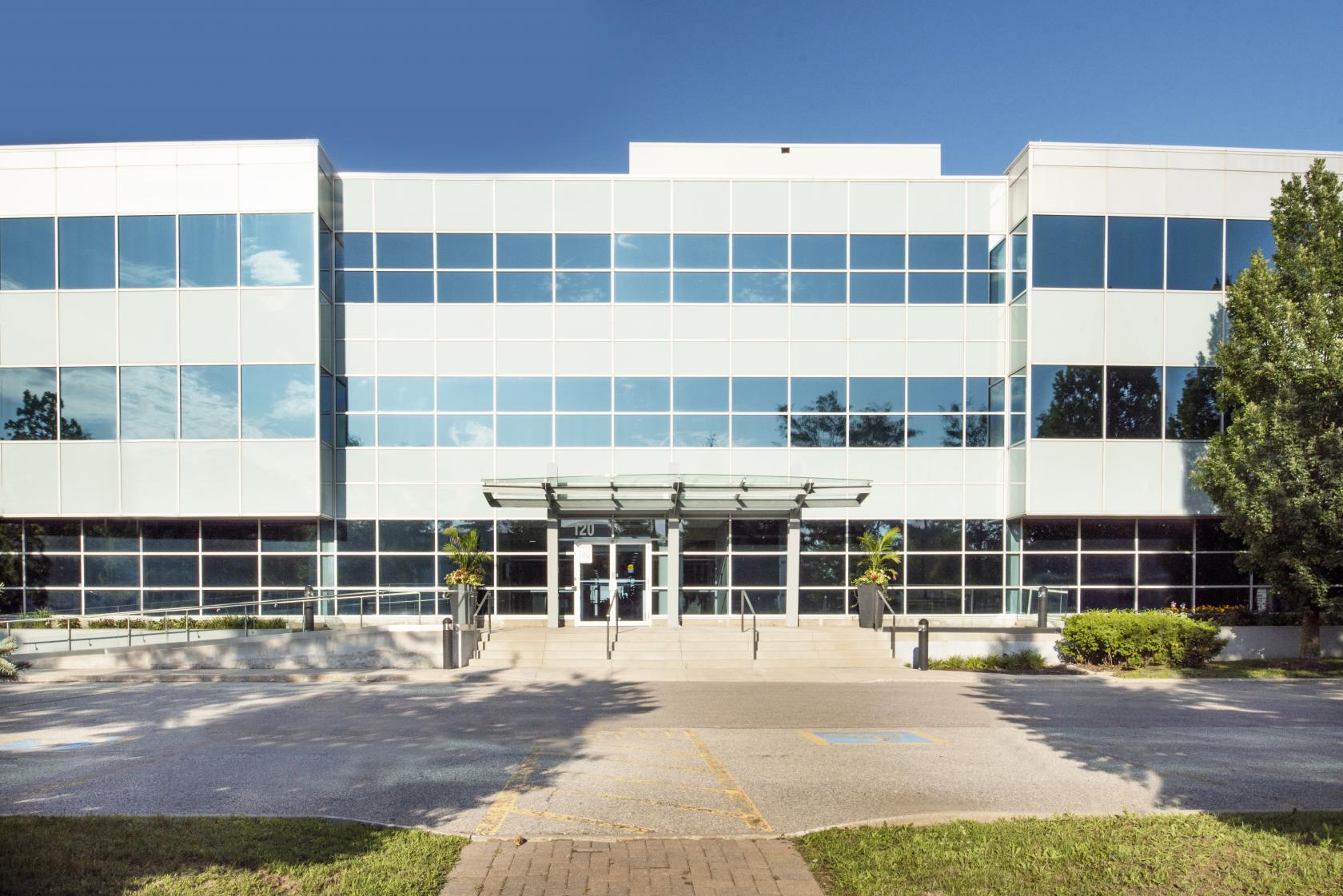 A modern coworking space with a glass-paneled exterior and prominent entrance at Venture X Richmond Hill.