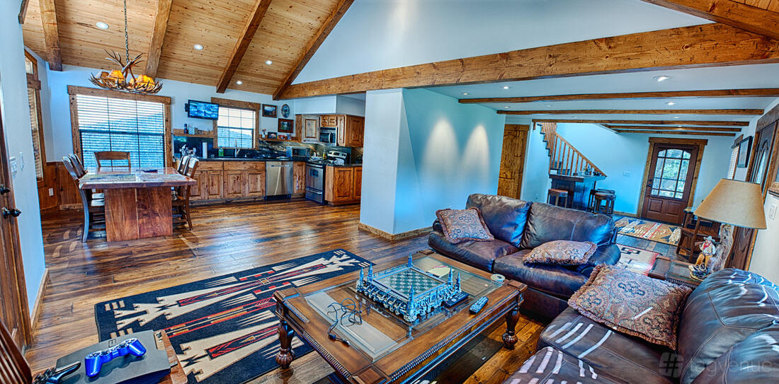 A photo and film studio in a house with wood-beamed ceilings, leather sofas, and an open kitchen at Shoot Houses.