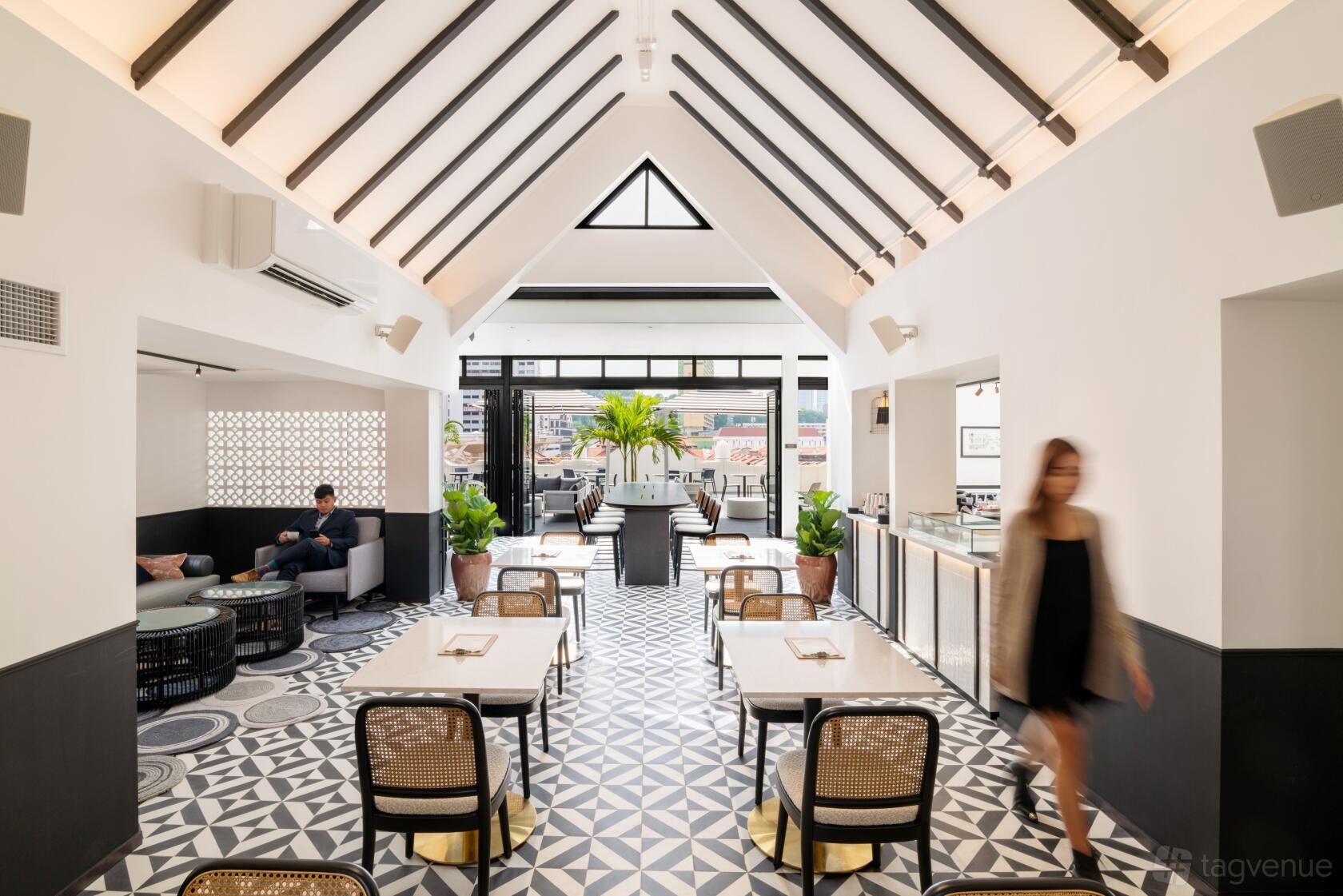 An event space with geometric tile flooring, vaulted ceiling, and glass doors leading to a terrace at The Great Room - South Bridge.