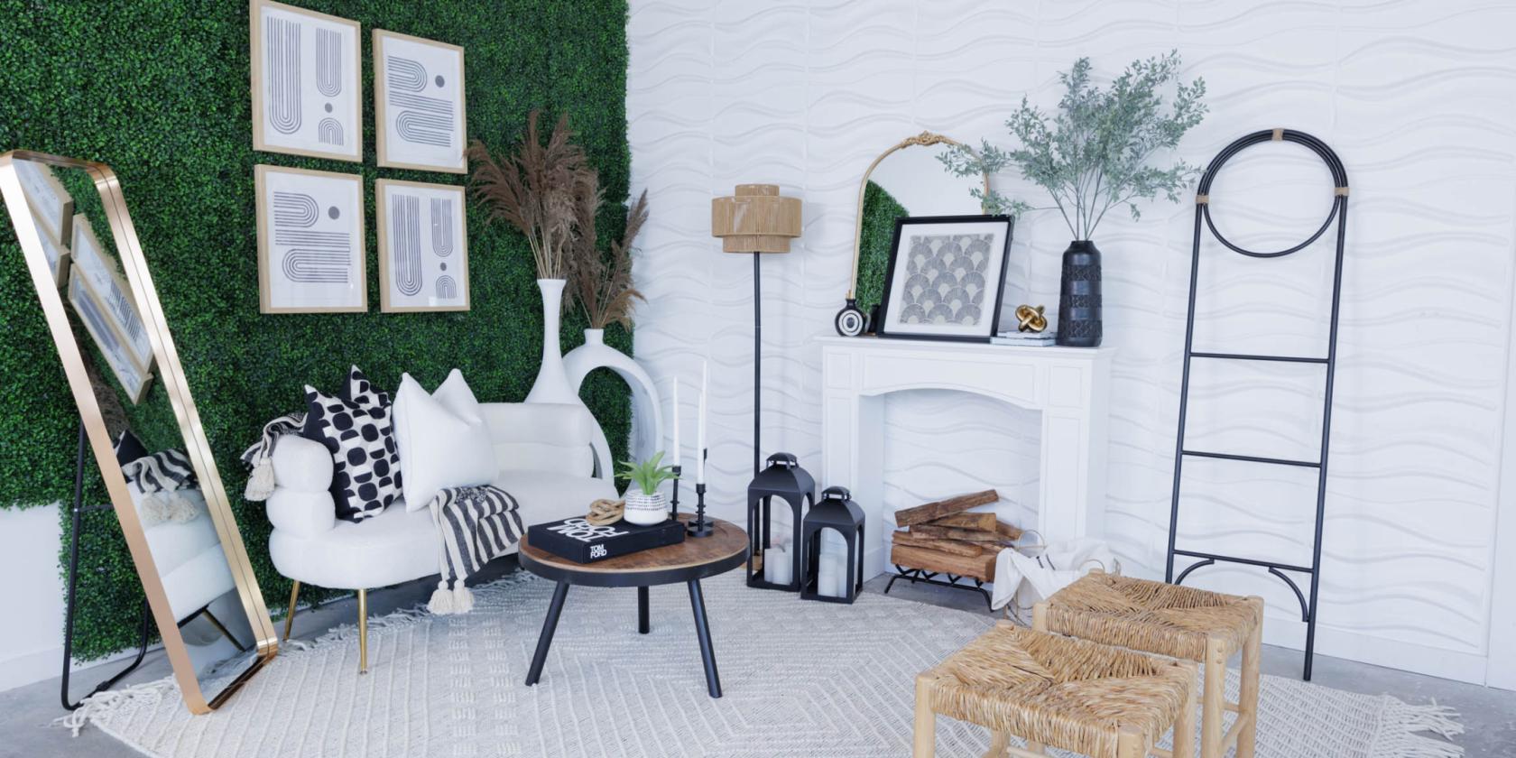 A photo studio with textured white walls, a faux greenery accent, modern decor, and natural light at Skyelight Studio.