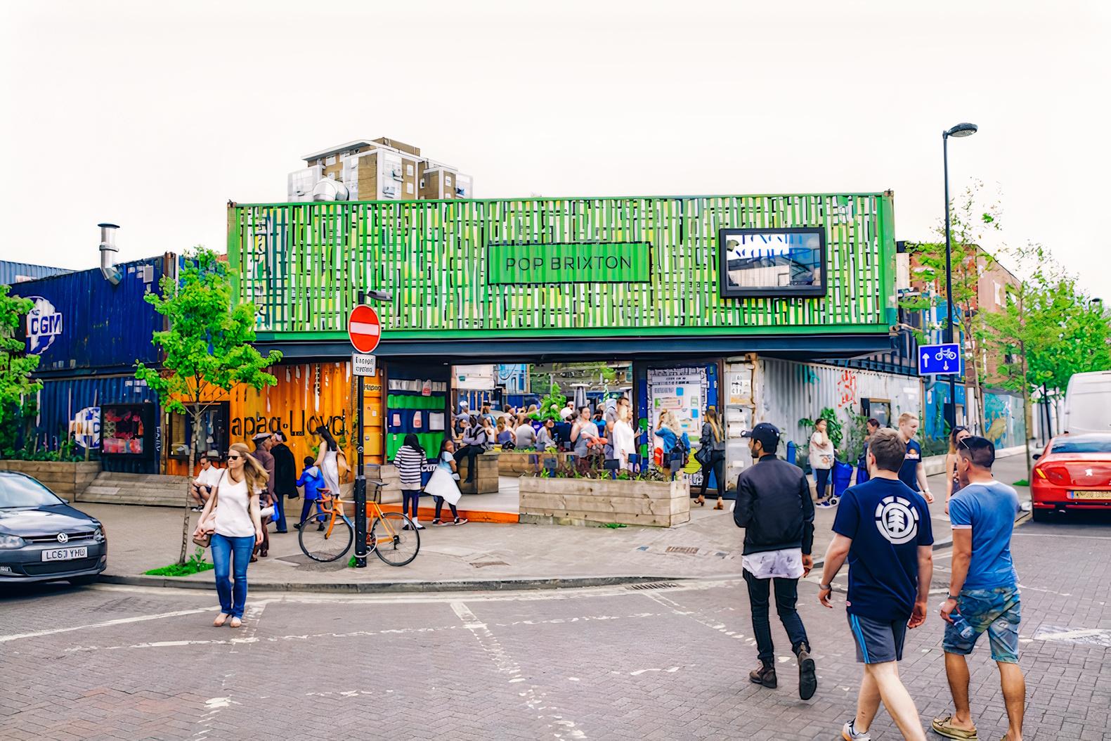 An event space made from repurposed shipping containers with a colorful facade at Pop Brixton.
