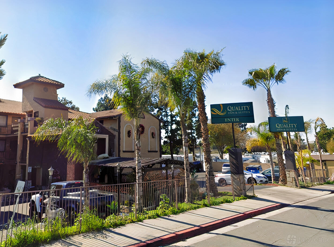 A meeting centre with stucco exterior, tiled roofs, and palm trees at Hotel Baja San Diego.