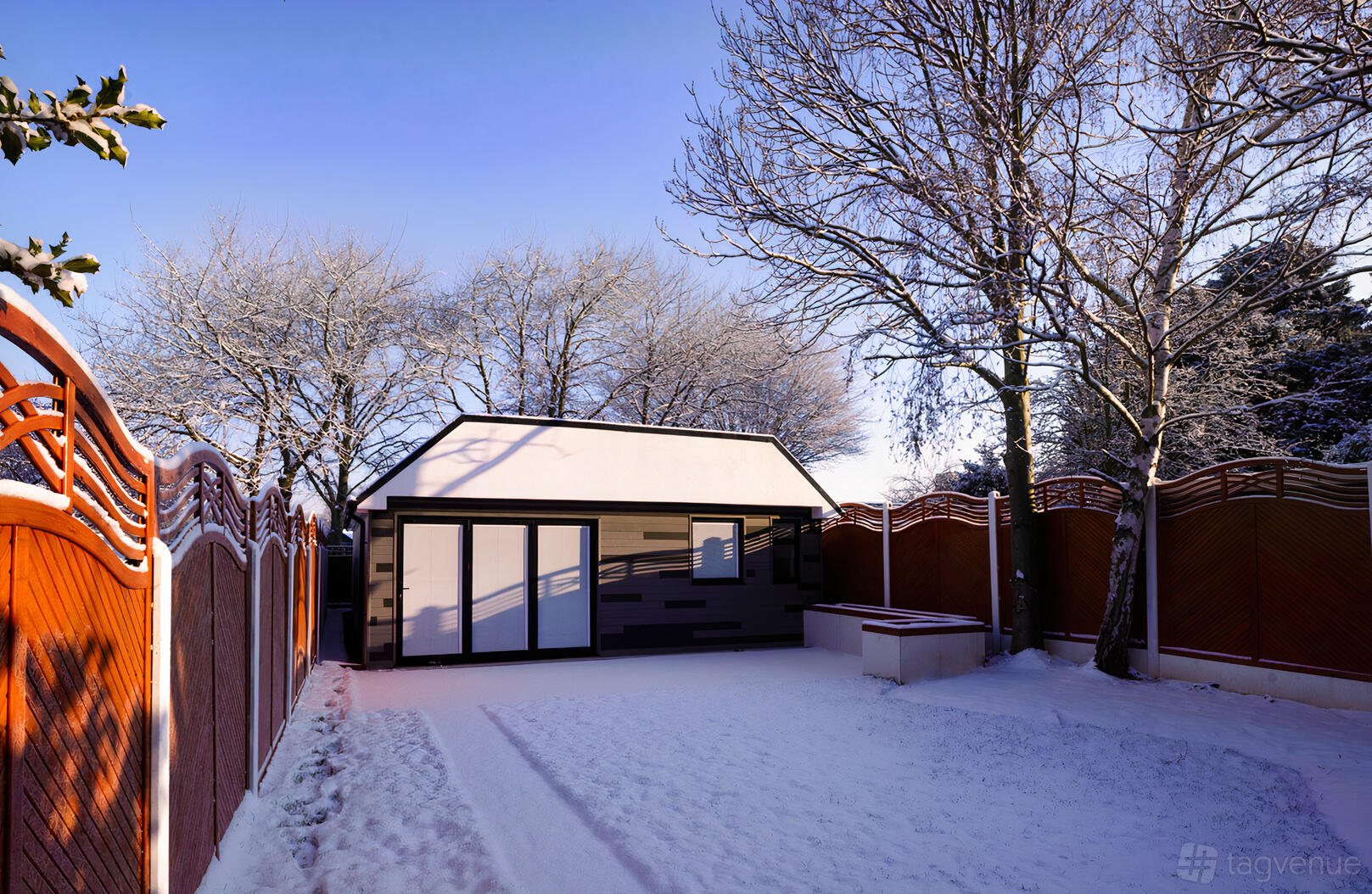 A film and photo studio with a snow-covered courtyard, wooden fencing, and a small modern building at Thelightfull Studio.