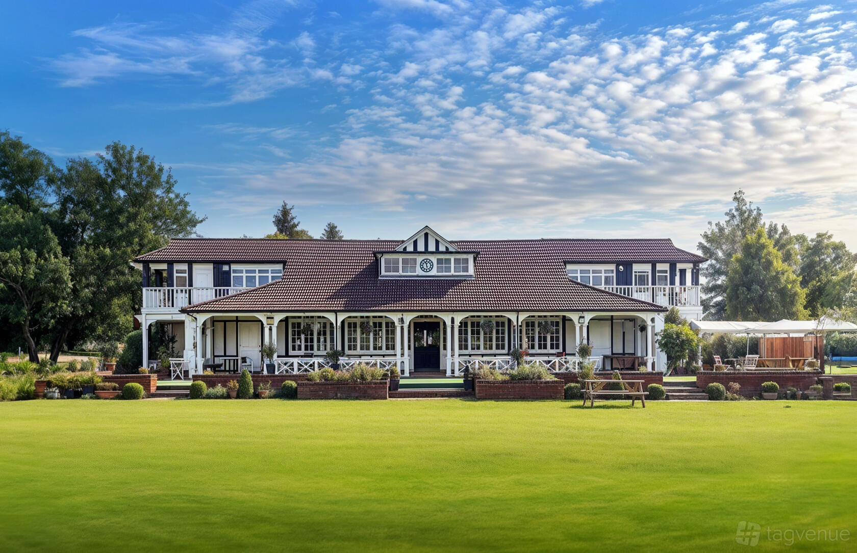 A versatile event space with a two-story clubhouse, wraparound porch, and manicured lawn at London Shenley Club.