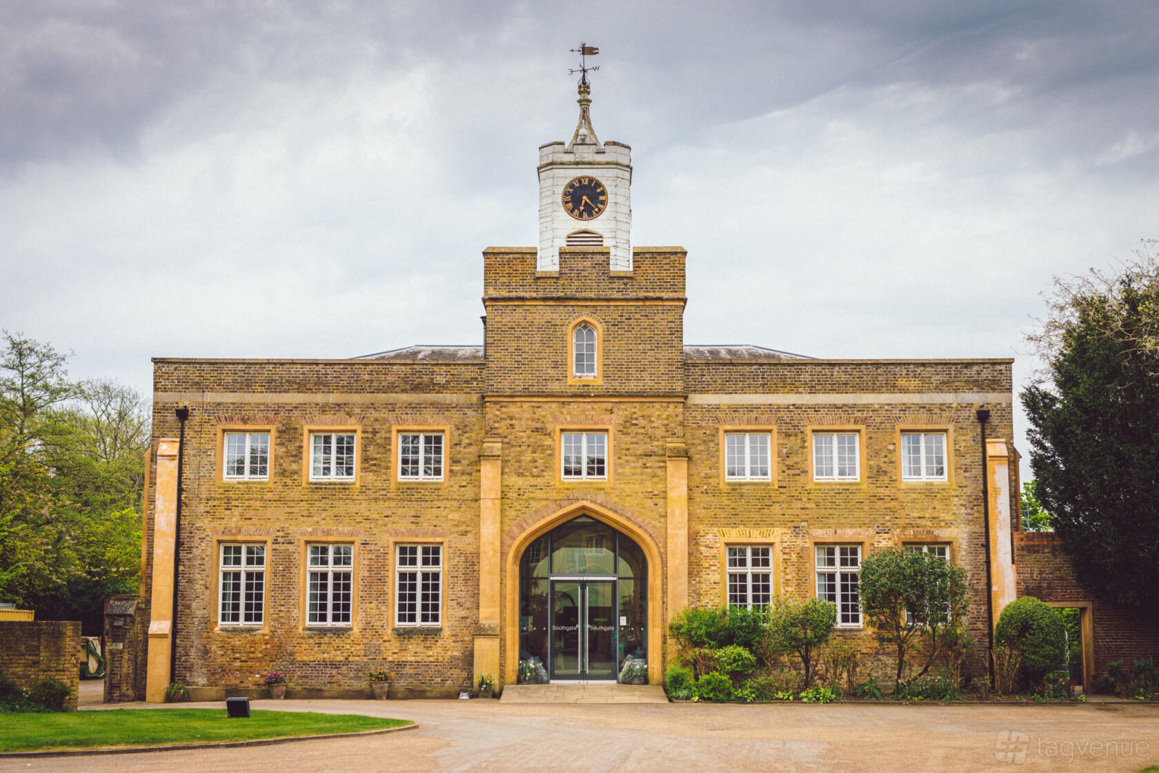 A conference centre with a brick facade, arched entrance, and tall windows at Southgate Conference Centre.