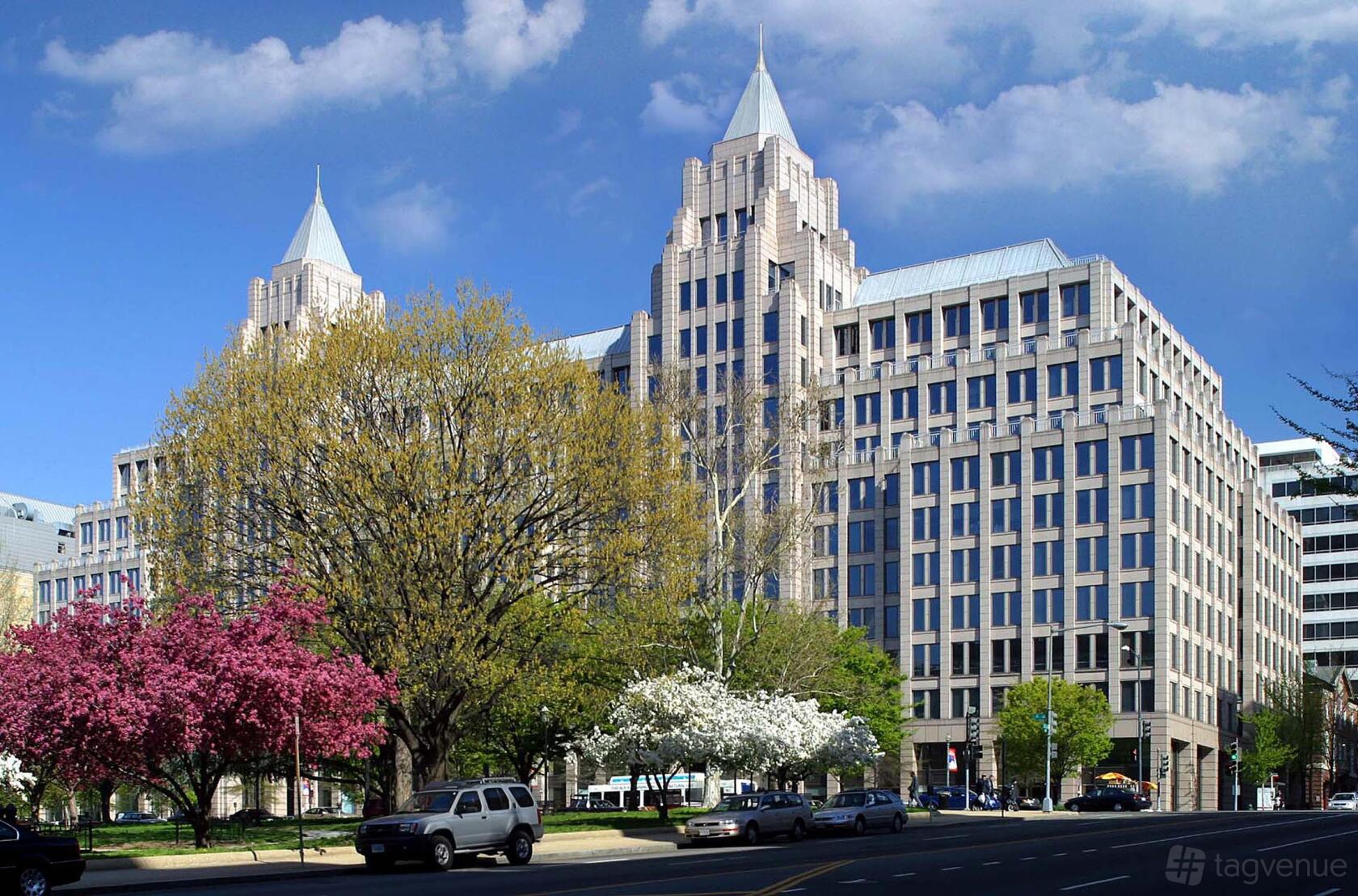 An office building with pointed towers, large windows, and blooming trees at Mindspace Washington DC.