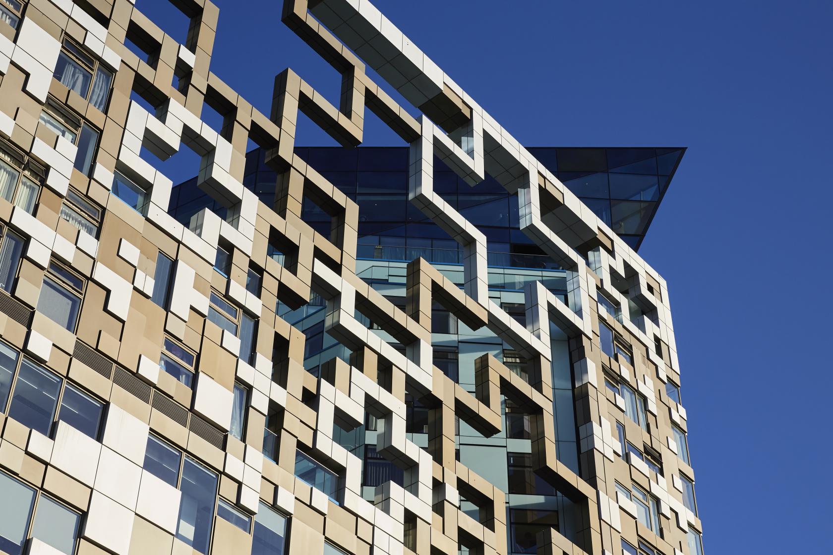 A versatile event space in a geometric-patterned building façade with glass accents at The Cube.