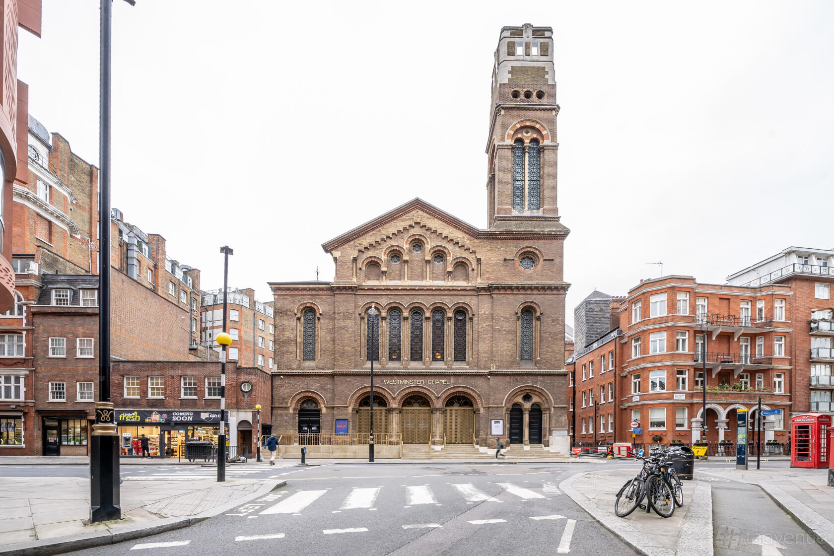 A historic church with arched windows, stone façade, and a tall bell tower at Westminster Chapel.