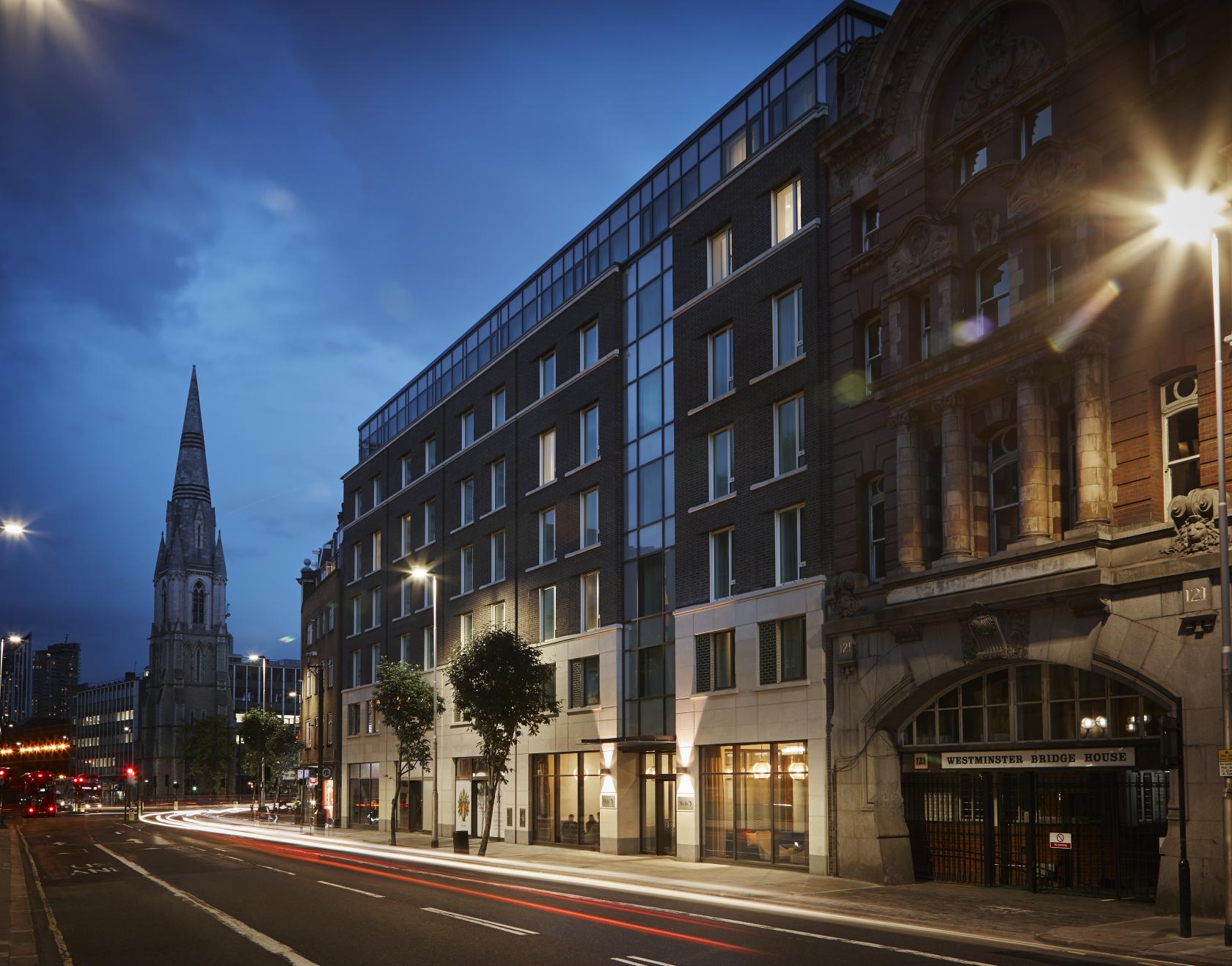 A hotel with modern glass façade and ground-floor windows on a city street at Marlin Waterloo.