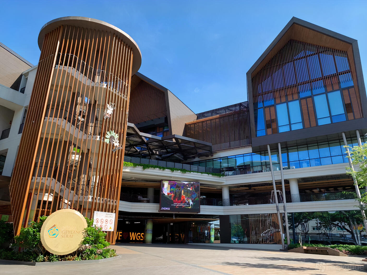 A contemporary dance studio building with wood slat exterior panels and glass windows at Rhythmix by D'Gymnastique Academy.